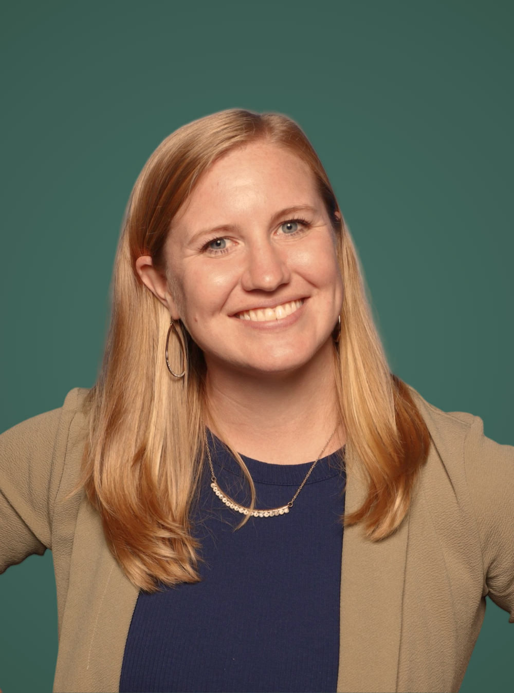 Woman with blonde hair and a beige cardigan against a green background
