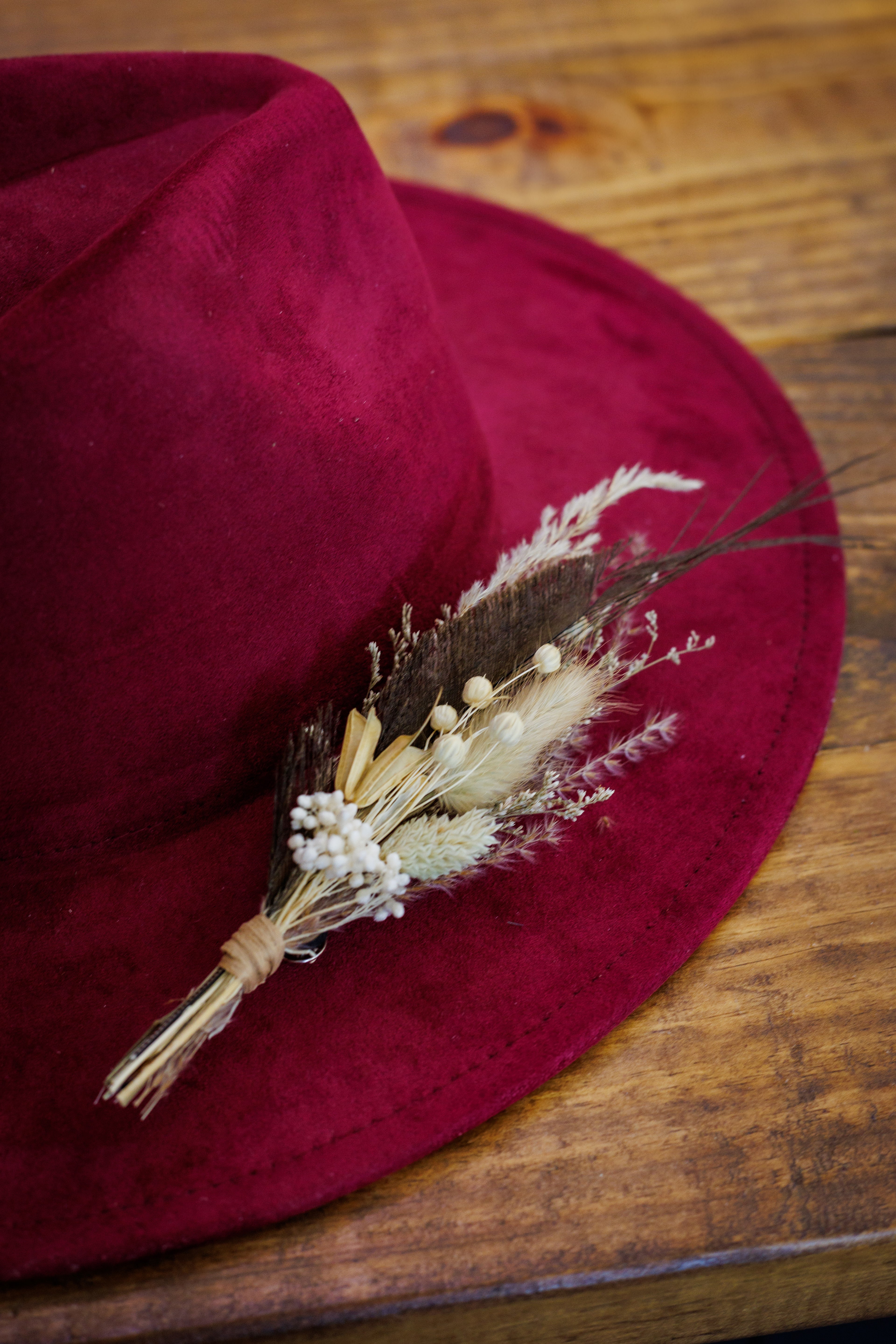 Red hat with decorative elements on a wooden surface