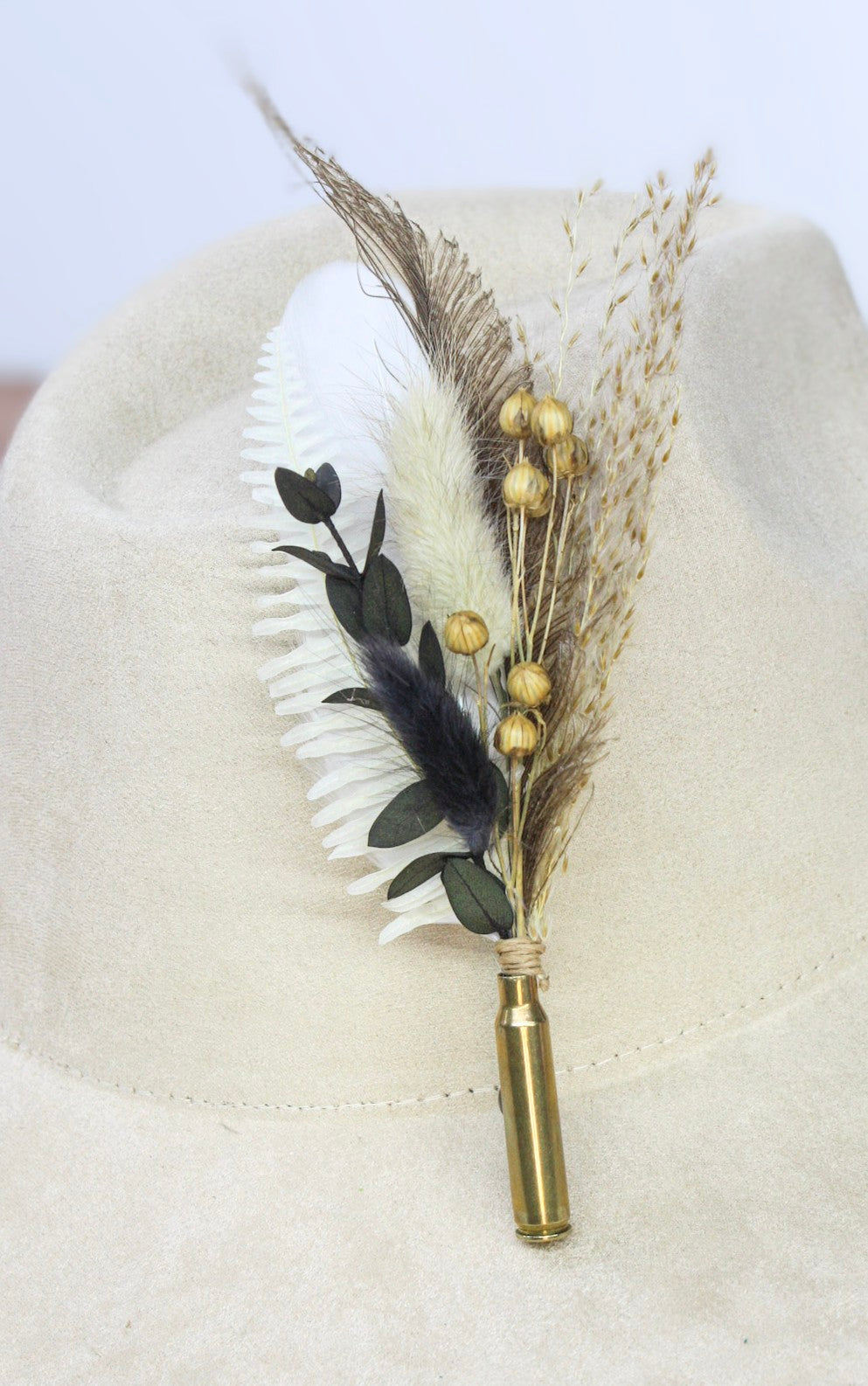 Bullet BrimBud hat pin Champagne with white fern, dark eucalyptus, and gold berries on a cream felt hat