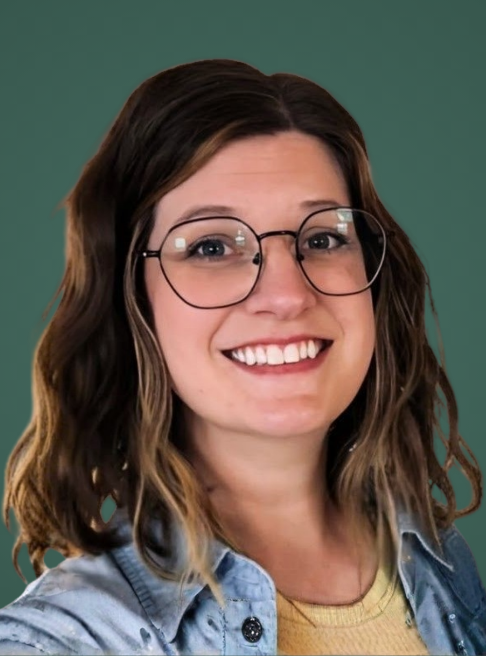Woman wearing glasses and a denim jacket against a green background