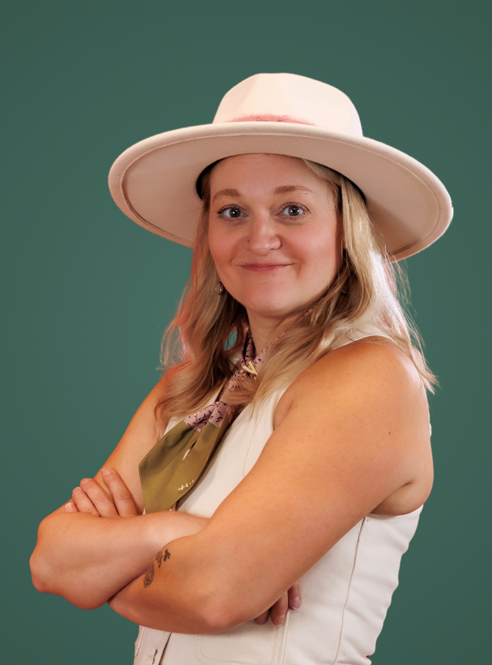 Woman wearing a wide-brimmed hat against a green background